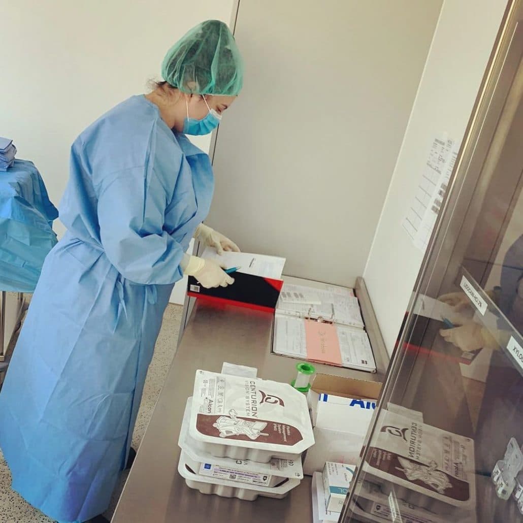 Mitarbeiterin in OP-Kleidung an einem Gerät im OP-Saal